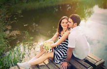 Sensual Romantic Couple In Love On Pier At The Lake In Sunny Day