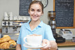 © highwaystarz - Waitress In Cafe Serving Customer With Coffee