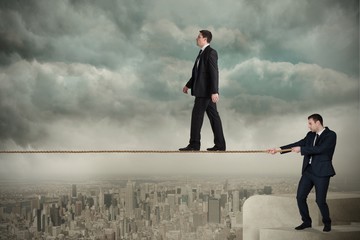 Poster - Young business man pulling a tightrope for businessman