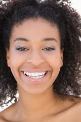 Wall Mural - Pretty girl with afro hairstyle smiling at camera