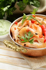 Sticker - fried prawns with chilli in a copper pan, Indian style