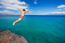 Man Jumping Off Cliff Into The Ocean