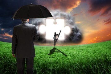 Poster - Composite image of mature businessman holding an umbrella