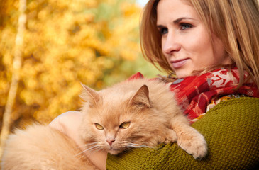 young girl with cat on natural background