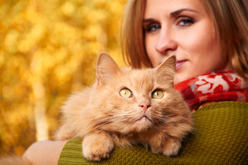 young girl with cat on natural background