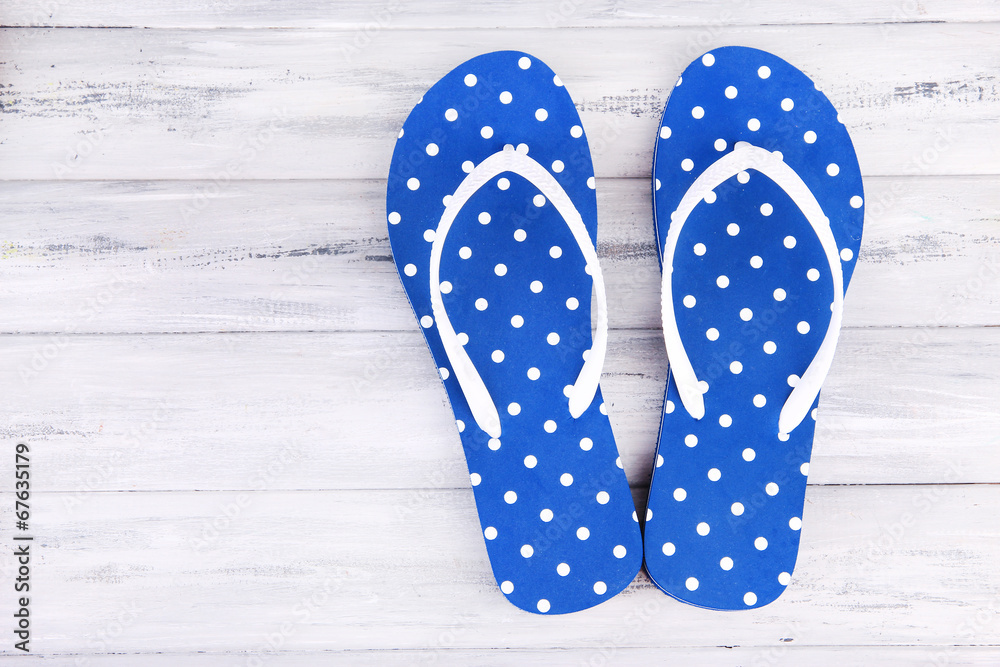 Color flip-flops on wooden background