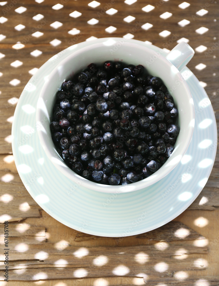 Useful blueberry in bowl on table, close-up