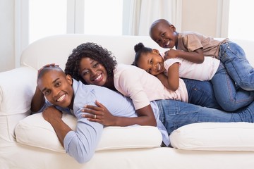 Happy family posing on the couch together