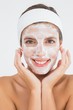 © WavebreakMediaMicro - Attractive woman having white cream on her face
