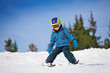 © Sergey Novikov - Small boy in ski mask and helmet learns skiing