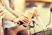Woman Hand Holding Coffee And Riding Bicycle