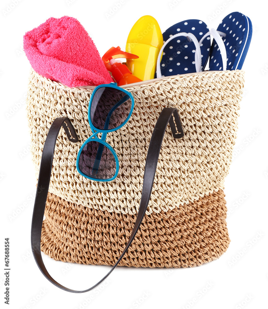 Summer wicker bag with accessories, isolated on white
