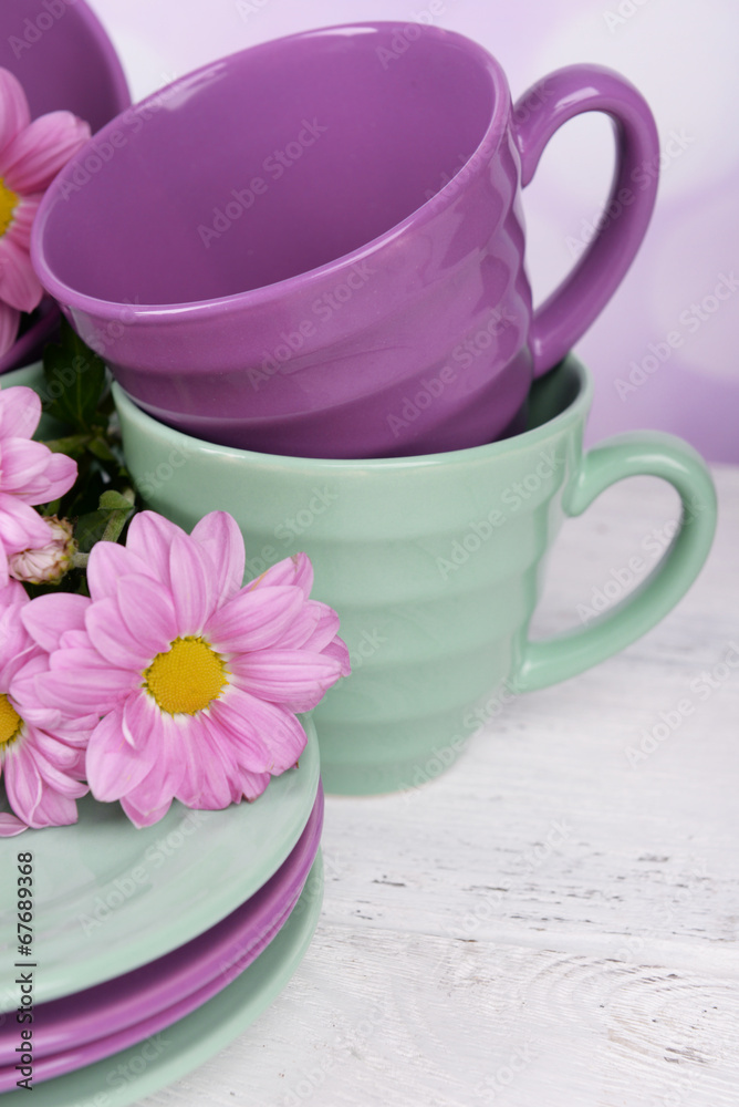 Bright cups and saucers with flowers