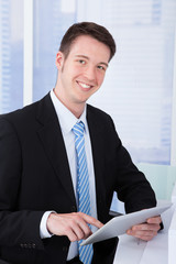 Poster - Confident Businessman Using Tablet Computer At Desk