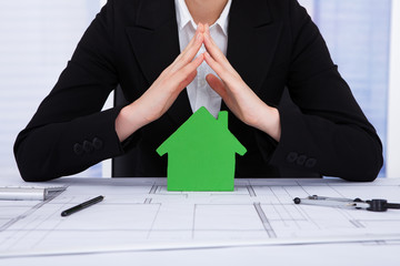 Poster - Businesswoman Protecting Green House Model