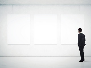 Wall Mural - gallery room and man looking at empty frames