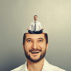 Canvas Print - man looking up at calm yoga man