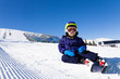 © Sergey Novikov - Small boy in ski mask sitting on the snow