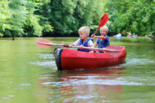 Two Happy School Boys Kayaking On The River