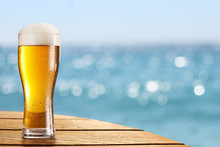 Beer Glass On A Blurred Background Of The Sea.