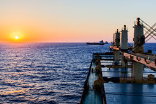 Cargo Ship Underway At Sunset