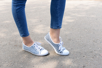 Pink sneakers on girl legs outdoors