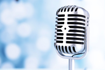 Wall Mural - Vintage microphone on light blue background