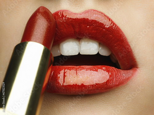 Obraz w ramie Close-up of woman's lips with bright fashion red glossy makeup.