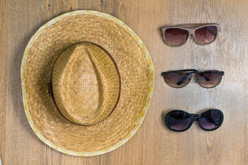 Top view of braided hat and three pair of glasses