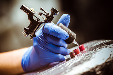 Tattooist makes a tattoo. Closeup