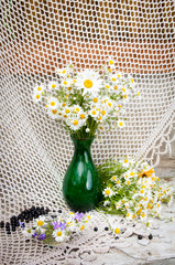 Wall Mural - chamomiles in a green vase still life