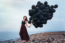 Beautiful Girl Walking With Black Balloons