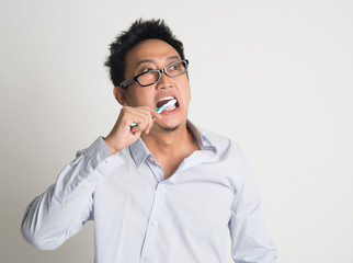 Businessman brushing teeth