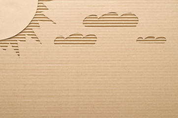 Sun and clouds cut out on cardboard