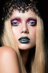 Fashion portrait of young woman with stage make-up