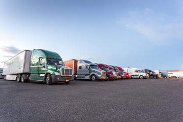 Many American trucks on parking lot.