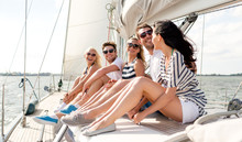 Smiling Friends Sitting On Yacht Deck