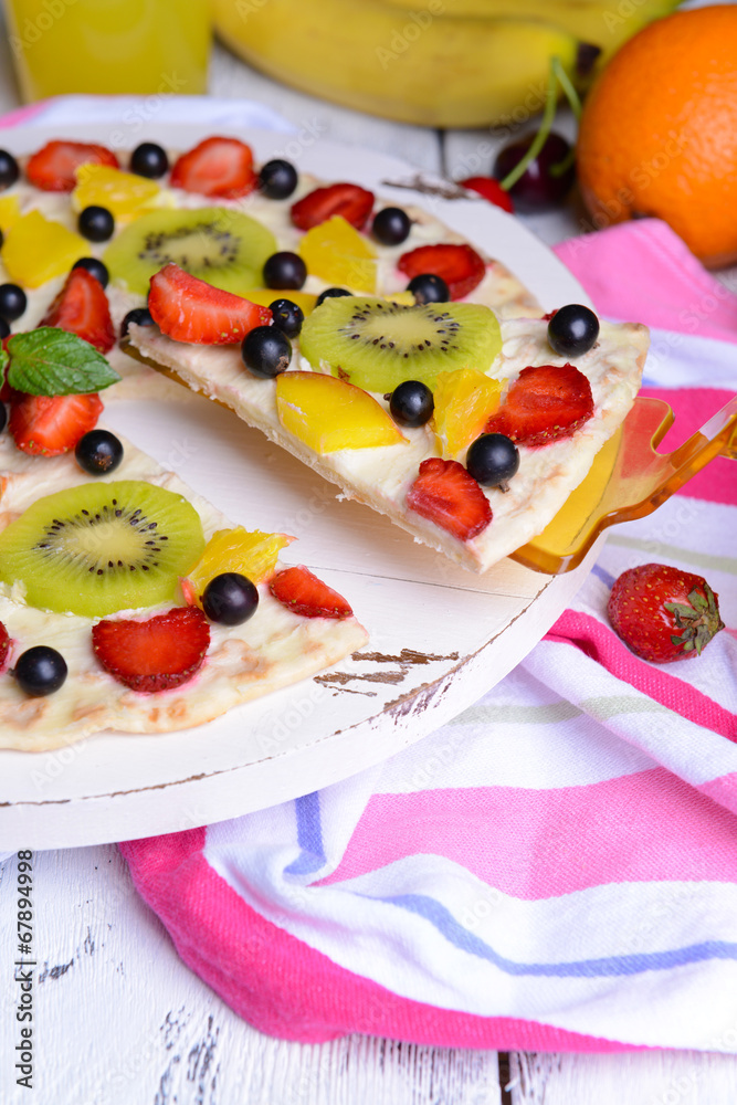 Sweet pizza with fruits on table close-up