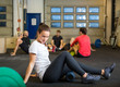 © Tyler Olson - Woman Doing Relaxation Exercise In Crossfit Gym