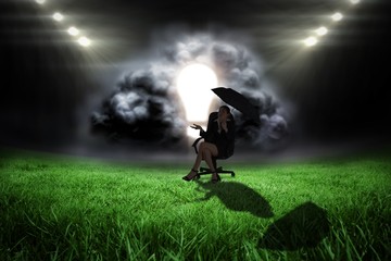 Poster - Composite image of young businesswoman holding umbrella