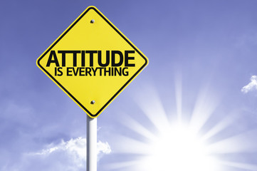 Attitude is Everything road sign with sun background