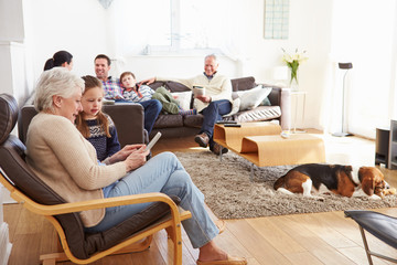 Multi Generation Family Relaxing At Home Together