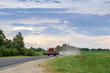 © AlexanderNikiforov - Combine tractor at the road in fields