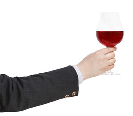 Wall Mural - side view of red wine glass in businessman hand