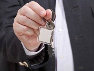 Wall Mural - front view of businessman hand with door keychain