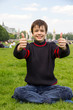 Cheerful teenager shows thumb up on the Esplanade des Invalides