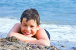 Happy smiling boy on the sea beach