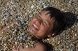 Happy young boy on the sea beach
