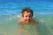 Happy young boy diver swims in the sea
