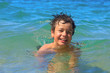 Happy young swims in the sea